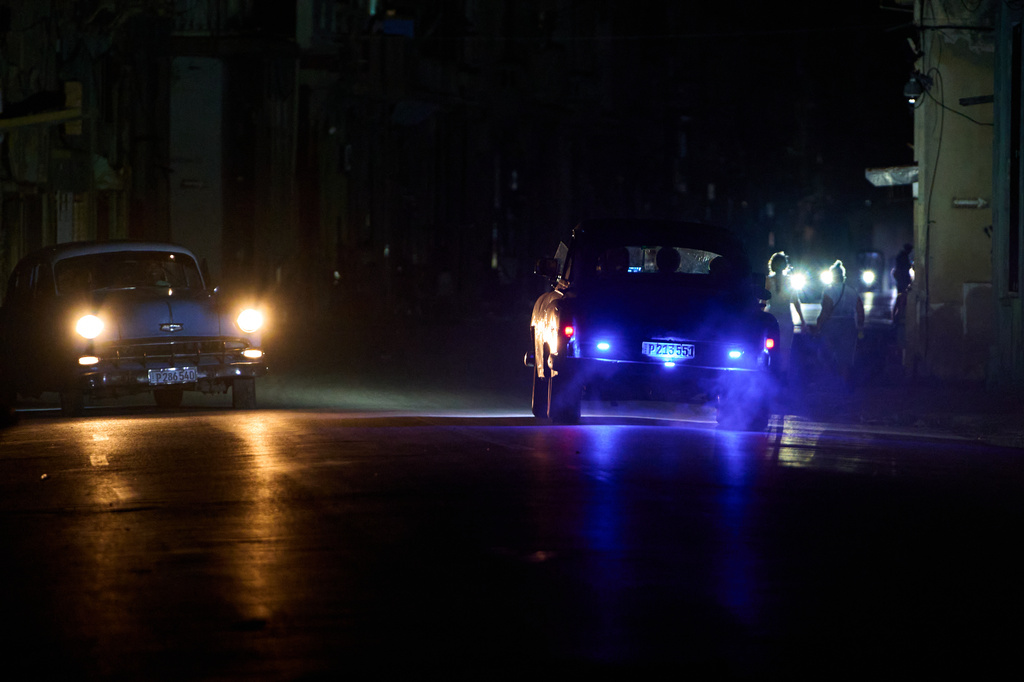 People drive American classic cars during a blackout in Havana, Cuba, Friday, July 10, 2026. (AP Photo/Ramon Espinosa)