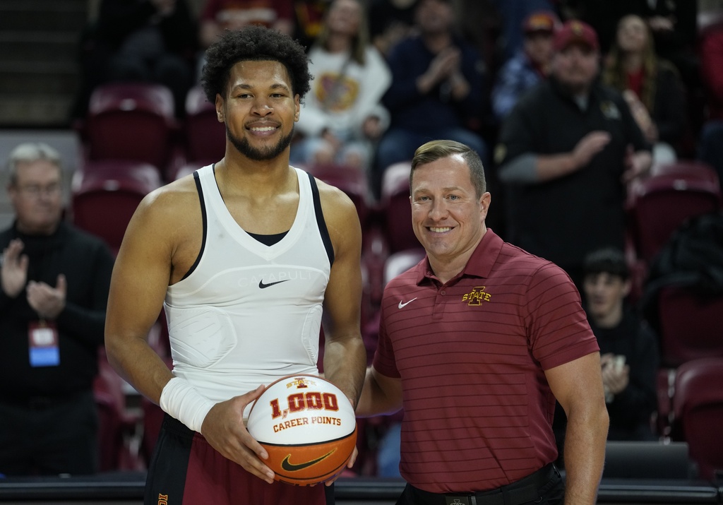 Iowa State head coach T.J. Otzelberger, right, poses with forward Joshua Jefferson, left, after Jefferson's scoring of 1,000 career points, before an NCAA college basketball game against Houston Christian, Monday, Dec. 29, 2025, in Ames, Iowa. (AP Photo/Matthew Putney)