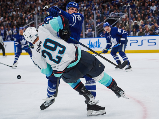 Toronto Maple Leafs' Jake McCabe (22) checks Seattle Kraken's Vince Dunn (29) during third period NHL hockey action in Toronto, on Saturday, Oct. 18, 2025. (Sammy Kogan/The Canadian Press via AP) Toronto Maple Leafs' Jake McCabe (22) checks Seattle Kraken's Vince Dunn (29) during third period NHL hockey action in Toronto, on Saturday, Oct. 18, 2025. (Sammy Kogan/The Canadian Press via AP)