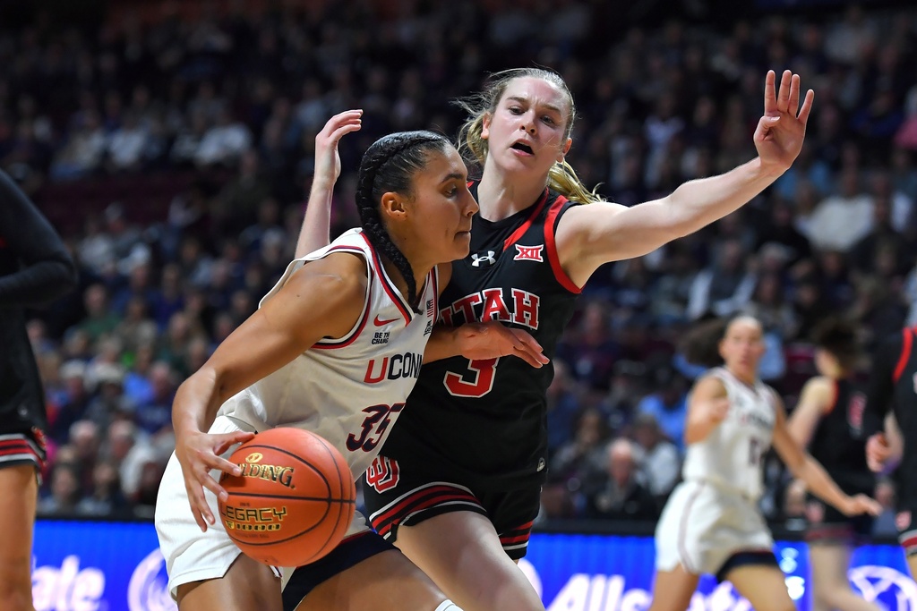 UConn guard Azzi Fudd (35) drives toward the basket as Utah guard Brooke Walker (3) defends in the first half of an NCAA college basketball game, Sunday, Nov. 23, 2025, in Uncasville, Conn. (AP Photo/Steven Senne)