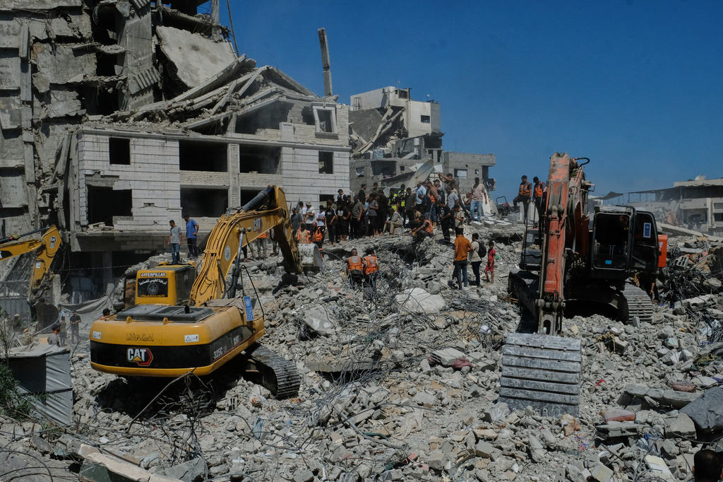 Palestinian civil defense crews search for bodies and survivors in the rubble of a collapsed building that housed displaced Palestinians and was heavily damaged during the Israel-Hamas war, in Gaza City, Wednesday, Sept. 16, 2026. (AP Photo/Jehad Alshrafi)