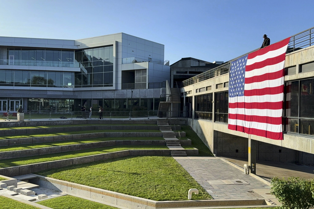 A national flag hangs over the site where conservative activist Charlie Kirk was shot and killed at Utah Valley University last week, Wednesday, Sept. 17, 2025, in Orem, Utah. (AP Photo/Jesse Bedayn)
