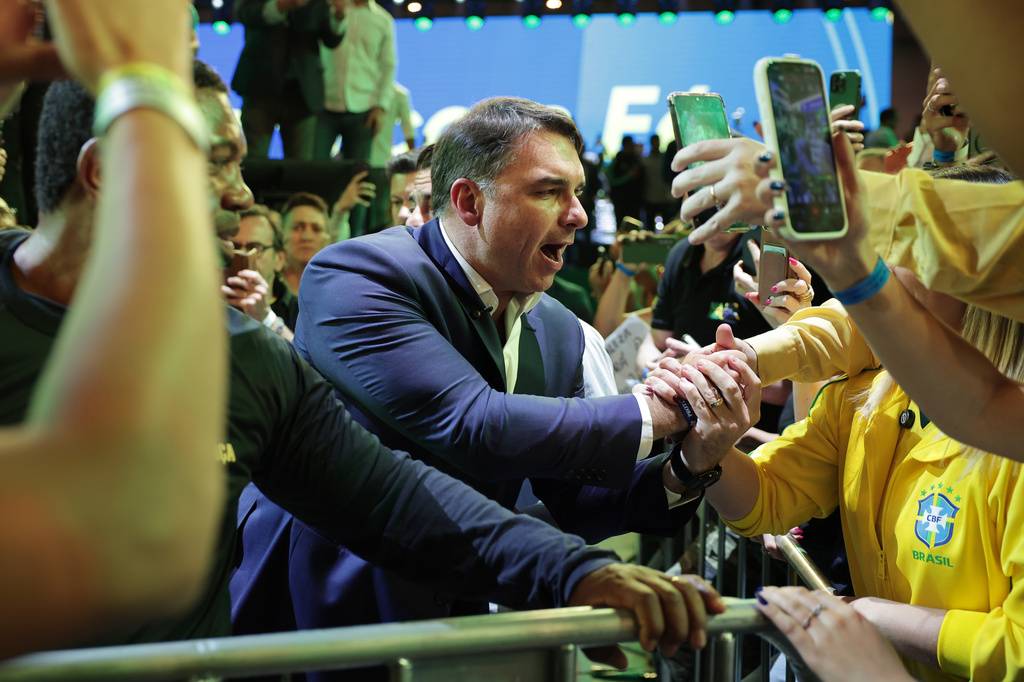 Brazilian Sen. Flavio Bolsonaro greets supporters as he arrives to the Liberal Party convention where he was confirmed as the party's presidential candidate, in Sao Paulo, Saturday, July 25, 2026. (AP Photo/Ettore Chiereguini)