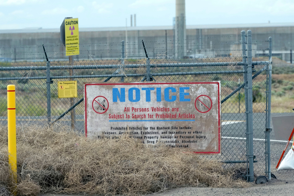 FILE - Caution signs are shown at a gate on the Hanford Nuclear Reservation, Thursday, June 2, 2022, in Richland, Wash. (AP Photo/Ted S. Warren, File)
