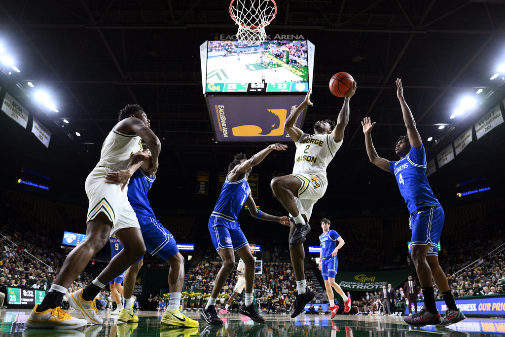George Mason guard Jahari Long (2) goes to the basket past Saint Louis guard Amari McCottry (4) during the first half of an NCAA college basketball game, Saturday, March 7, 2026, in Fairfax, Va. (AP Photo/Nick Wass)