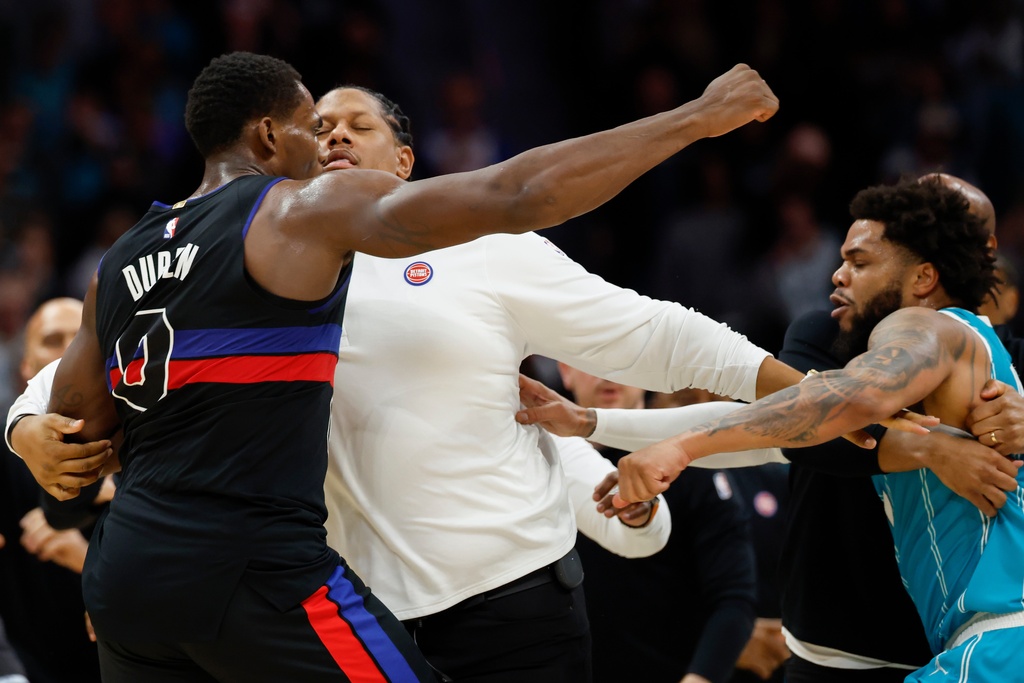 Detroit Pistons center Jalen Duren, left, throws punches with Charlotte Hornets forward Miles Bridges, right, during a fight on the court in the second half of an NBA basketball game in Charlotte, N.C., Monday, Feb. 9, 2026. (AP Photo/Nell Redmond)