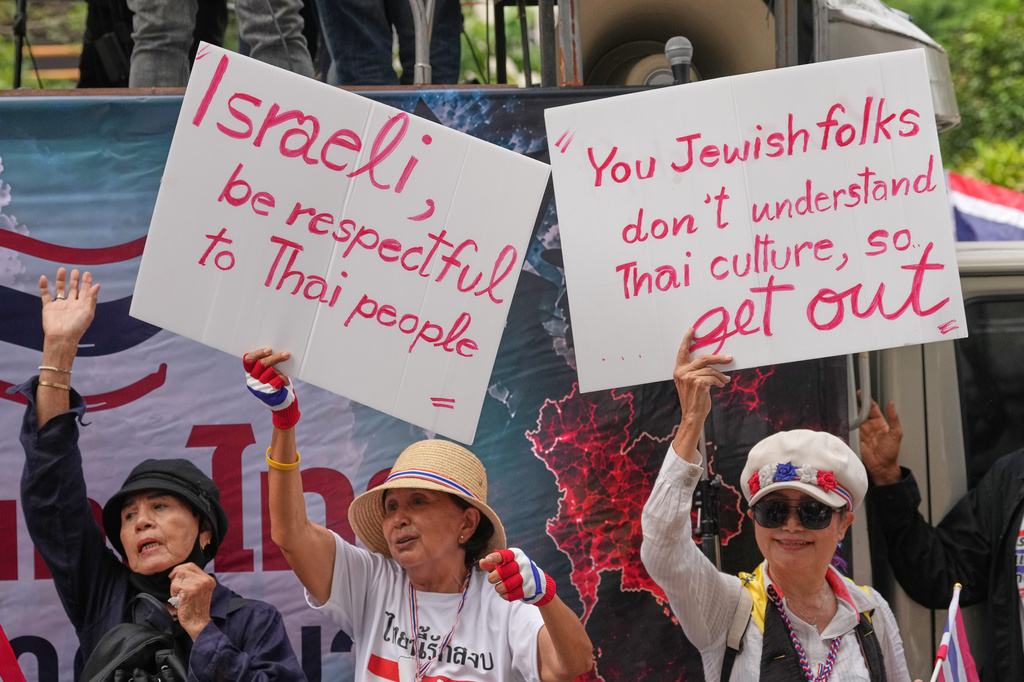Protesters holding signs attend a demonstration demanding an end to alleged land-grabbing by foreigners, in front of Israeli Embassy in Bangkok, Thailand, Thursday, Sept. 10, 2026. (AP Photo/Sakchai Lalit)