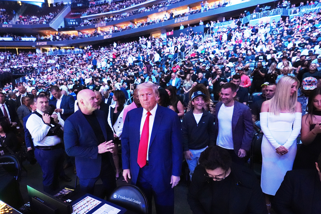 FILE - President Donald Trump attends the UFC-316 mixed martial arts event, at the Prudential Center, June 7, 2025, in Newark, N.J., as UFC's Dana White, left, looks on. (AP Photo/Frank Franklin II, File)