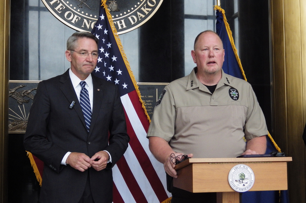 North Dakota Republican Attorney General Drew Wrigley, left, listens as Morton County Sheriff Kyle Kirchmeier addresses reporters at the state Capitol in Bismarck, N.D., on Thursday, June 11, 2026. (AP Photo/Jack Dura)