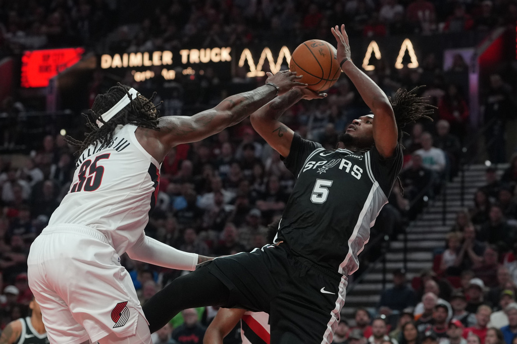 San Antonio Spurs guard Stephon Castle (5) shoots against Portland Trail Blazers center Robert Williams III (35) during the second half in Game 3 of a first-round NBA playoffs basketball series in Portland, Ore, Friday, April 24, 2026. (AP Photo/Jenny Kane)