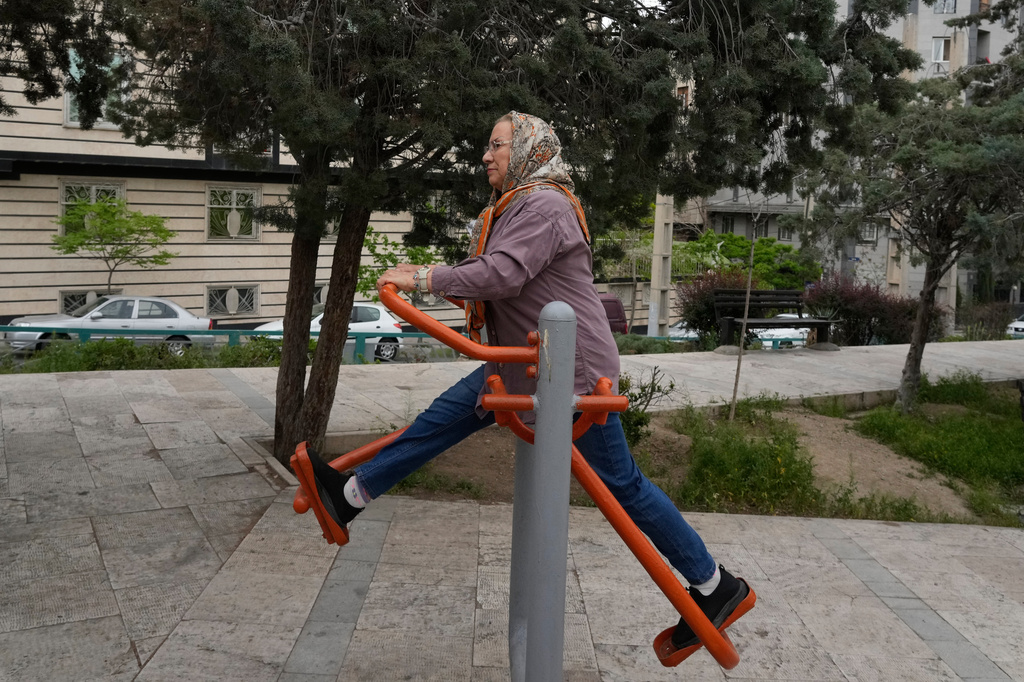 A woman exercises at a park in Tehran, Iran, Sunday, April 19, 2026. (AP Photo/Vahid Salemi)