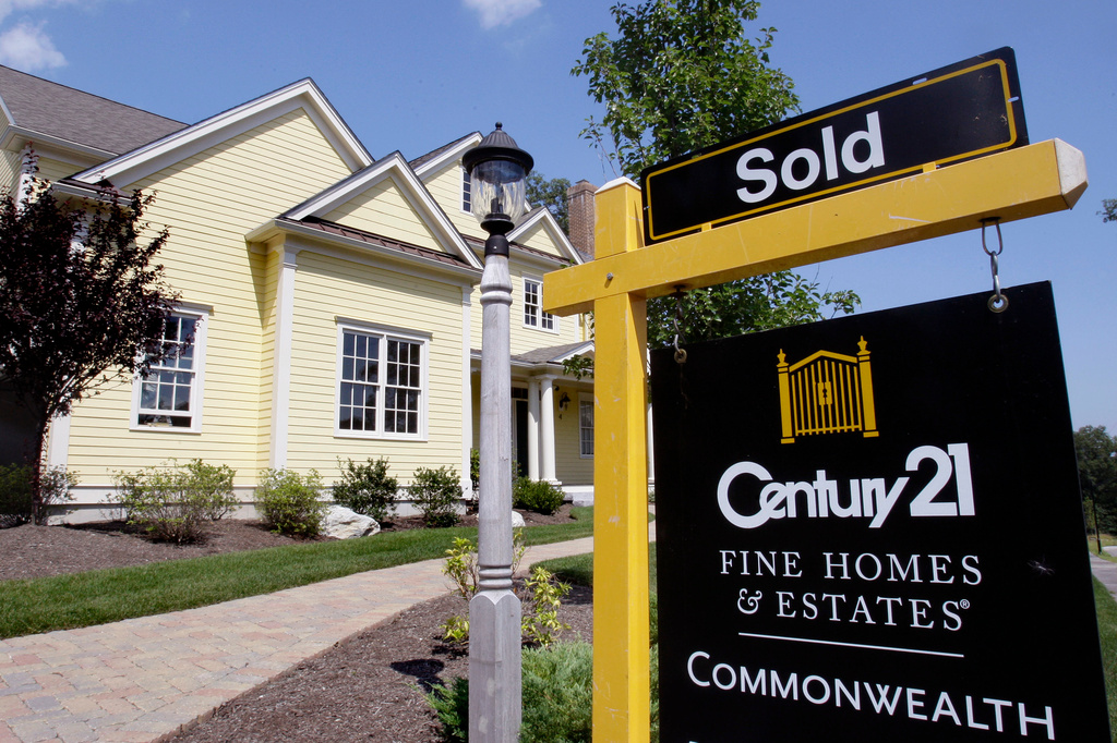 FILE - A sold sign is posted outside a newly constructed luxury home in Wellesley, Mass., Aug. 25, 2009. (AP Photo/Charles Krupa, File)