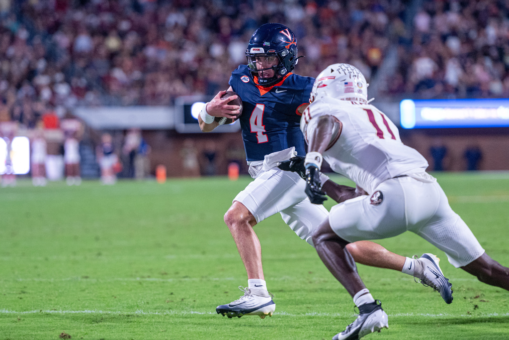 Virginia quarterback Chandler Morris (4) runs the ball in for a touchdown during the first half of an NCAA college football game, Friday, Sept. 26 2025, in Charlottesville, Va. (AP Photo/Robert Simmons)