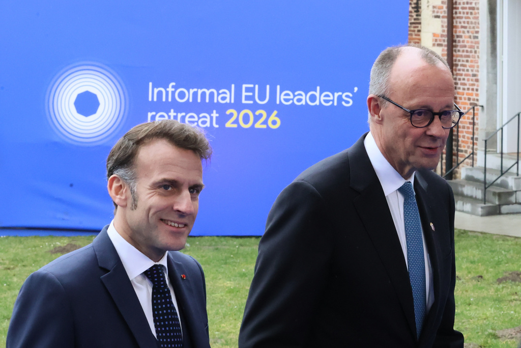 French President Emmanuel Macron, left, and Germany's Chancellor Friedrich Merz arrive for the EU summit at Alden Biesen Castle in Bilzen-Hoeselt, Belgium, Thursday, Feb. 12, 2026. (AP Photo/Francois Walschaerts)