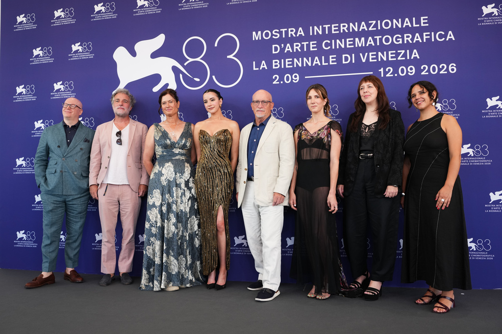 Producer Tyler DiNapoli, from left, producer Nick Shumaker, producer Jessie Deeter, Ashley St. Clair, director Alex Gibney, Zoë Schiffer and producer Erin Edeiken pose for photographers at the photo call for the documentary film 'Musk' during the 83rd edition of the Venice Film Festival in Venice, Italy, on Tuesday, Sept. 8, 2026. (Photo by Scott A Garfitt/Invision/AP)