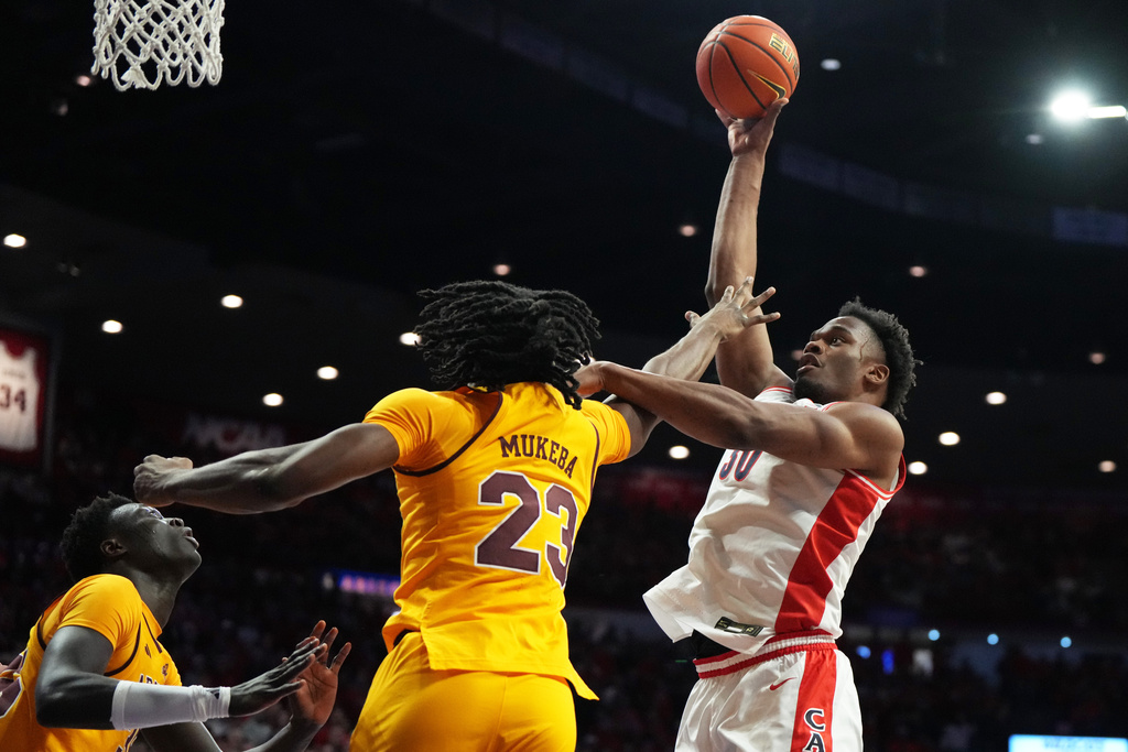 Arizona forward Tobe Awaka shoots over Arizona State forward Allen Mukeba (23) during the first half of an NCAA college basketball game, Wednesday, Jan. 14, 2026, in Tucson, Ariz. (AP Photo/Rick Scuteri)