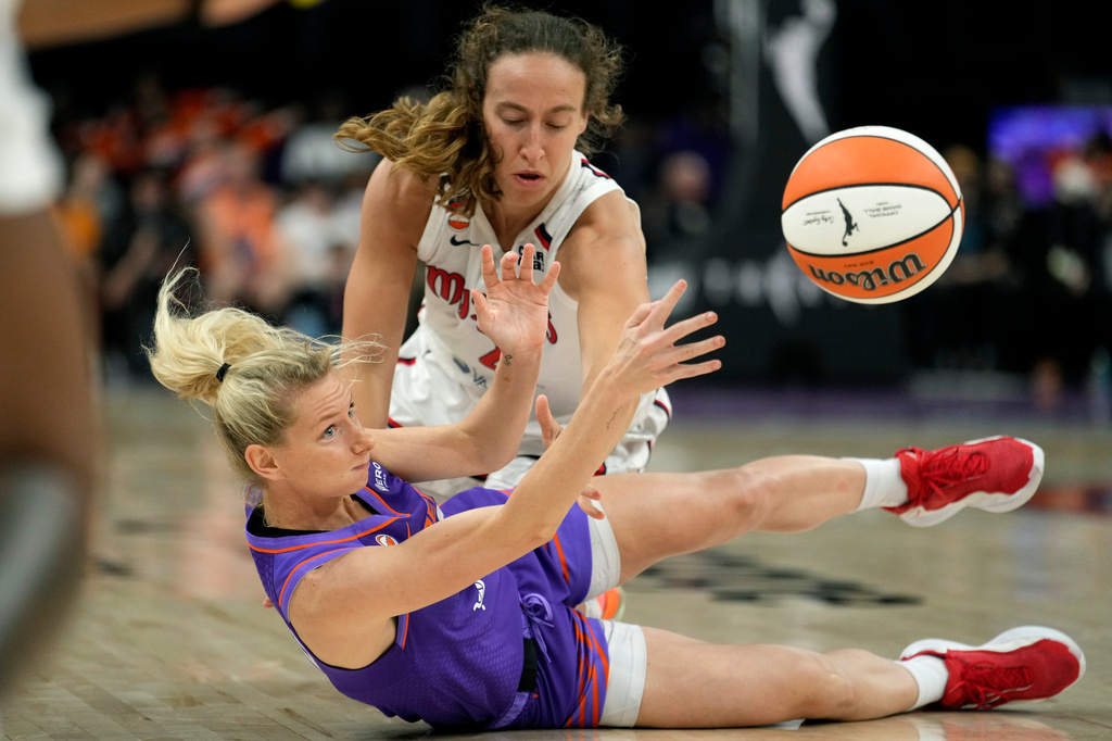 Phoenix Mercury guard Lexi Held, left, passes the ball away from Washington Mystics guard Alicia Florez during the second half of a WNBA basketball game, Thursday, Aug. 27, 2026, in Phoenix. (AP Photo/Ross D. Franklin)
