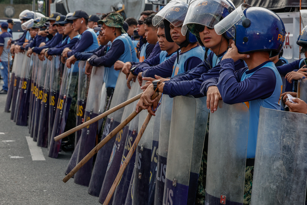 Police personnel line up and secure a road near a protest march in Quezon City, Philippines Monday, July 27, 2026, ahead of the State of the Nation Address by President Marcos Jr. (AP Photo/Gerard Carreon)