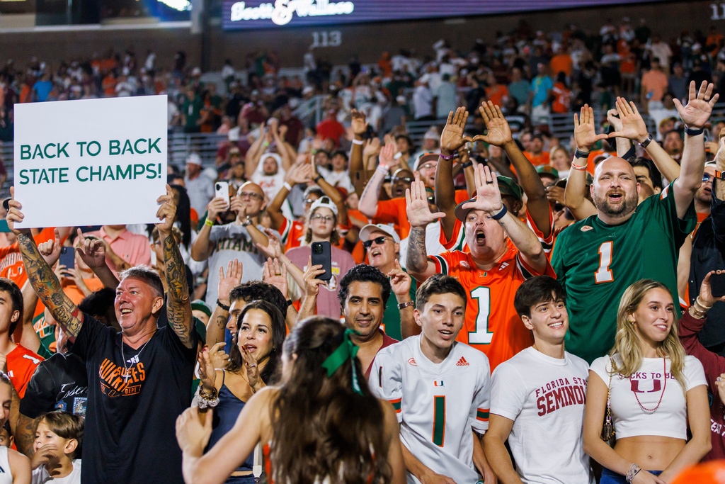 Miami fans celebrate defeating Florida State in a NCAA college football game, Saturday, Oct. 4, 2025, in Tallahassee, Fla. (AP Photo/Colin Hackley)
