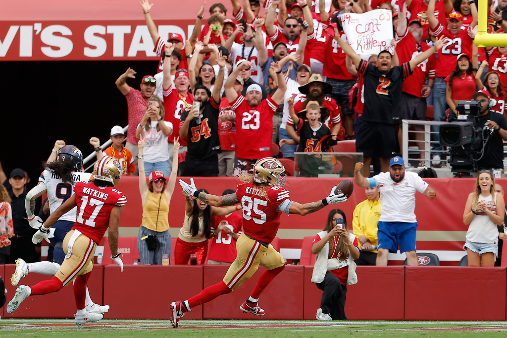 Fan react as San Francisco 49ers tight end George Kittle (85) celebrates after scoring against the Denver Broncos during the second half of an NFL football game in Santa Clara, Calif., Sunday, Oct. 4, 2026. (AP Photo/Kelley L. Cox)