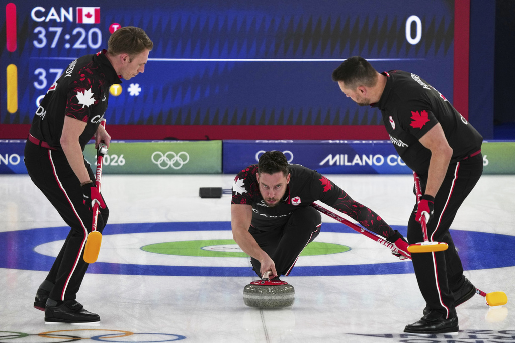 Canada's Brett Gallant, center, Ben Hebert, right, and Marc Kennedy in action during the men's curling round robin session against Germany, at the 2026 Winter Olympics, in Cortina d'Ampezzo, Italy, Wednesday, Feb. 11, 2026. (AP Photo/Misper Apawu)