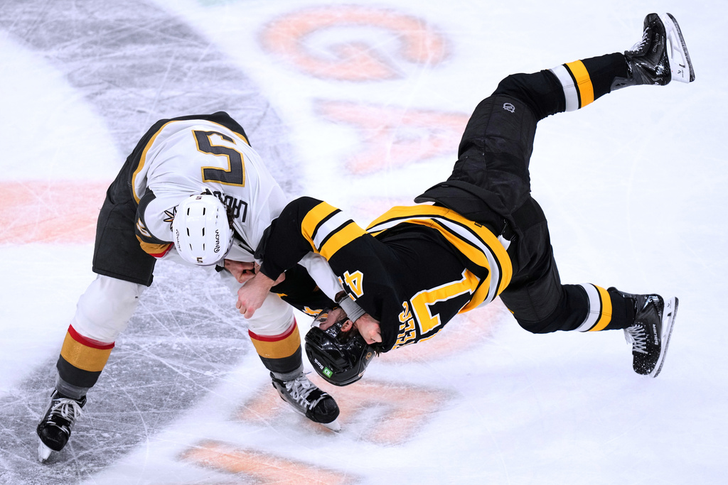 Boston Bruins center Mark Kastelic, right, is dropped to the ice by Vegas Golden Knights defenseman Jeremy Lauzon (5) during a fight in the first period of an NHL hockey game, Thursday, Jan. 22, 2026, in Boston. (AP Photo/Charles Krupa)