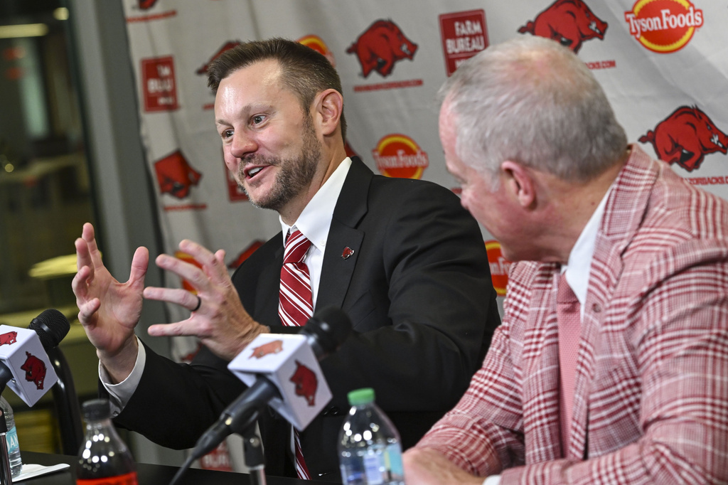 FILE - Arkansas's new head football coach Ryan Silverfield, left, speaks to reporters during an NCAA college football news conference, Dec. 4, 2025, in Fayetteville, Ark. (Hank Layton/The Northwest Arkansas Democrat-Gazette via AP, File)