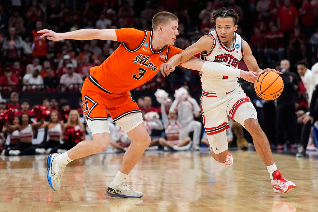 FILE - Houston guard Kingston Flemings (4) drives past Illinois guard Kylan Boswell (4) during the first half in the Sweet 16 of the NCAA college basketball tournament, March 26, 2026, in Houston. (AP Photo/Ashley Landis, File)
