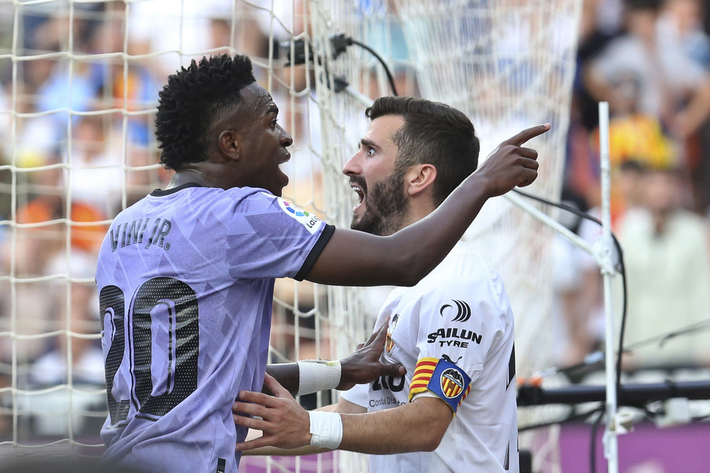 FILE - Real Madrid's Vinicius Junior, left, confronts Valencia fans as Valencia's Jose Luis Gaya reacts during a Spanish La Liga soccer match between Valencia and Real Madrid, at the Mestalla stadium in Valencia, Spain, Sunday, May 21, 2023. (AP Photo/Alberto Saiz, File)
