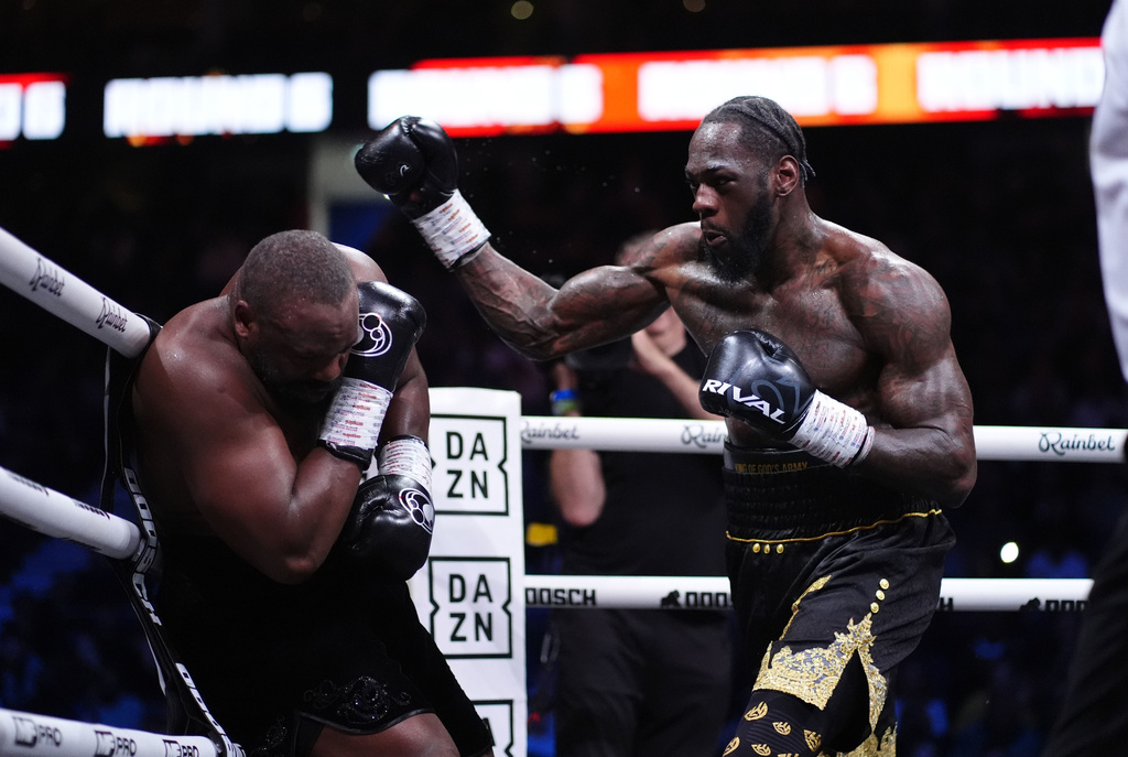 Boxer Deontay Wilder, right, punches Derek Chisora in a fight in London, Saturday April 4, 2026.(Adam Davy/PA via AP)