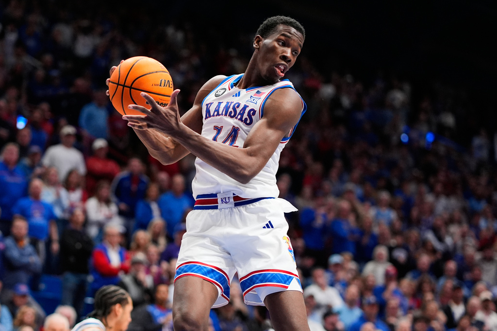 Kansas guard Melvin Council Jr. (14) gets a rebound during overtime of an NCAA college basketball game against TCU, Tuesday, Jan. 6, 2026, in Lawrence, Kan. (AP Photo/Charlie Riedel)