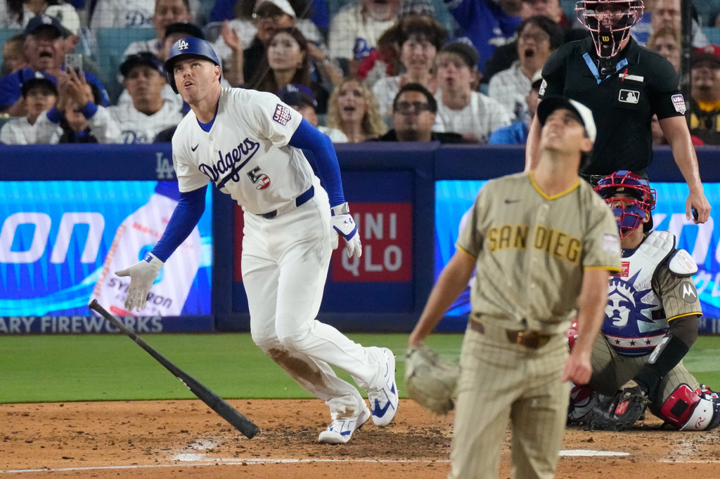 Los Angeles Dodgers' Freddie Freeman, left, heads to first for a solo home run as San Diego Padres pitcher Kyle Hart, second from left, and catcher Luis Campusano watch during the sixth inning of a baseball game Saturday, July 4, 2026, in Los Angeles. (AP Photo/Mark J. Terrill)
