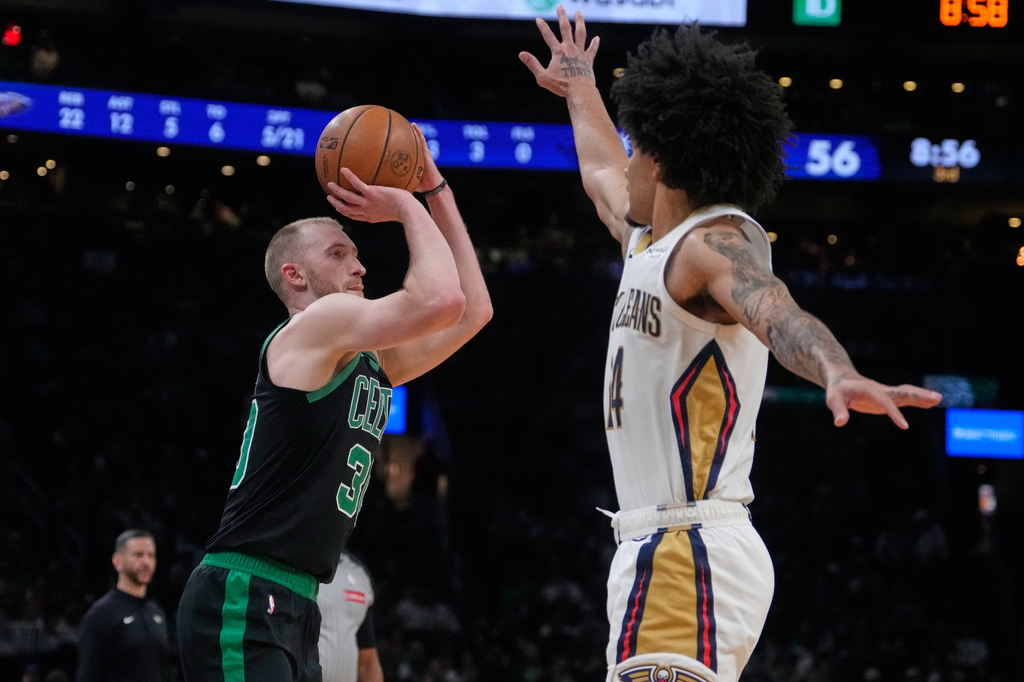 Boston Celtics forward Sam Hauser (30) takes a 3-point shot over New Orleans Pelicans guard Micah Peavy during the second half of an NBA basketball game, Friday, April 10, 2026, in Boston. (AP Photo/Charles Krupa)