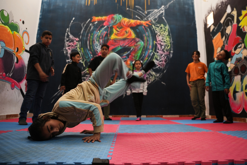 Palestinian children practice breakdancing in a dance studio in Nuseirat, central Gaza Strip, Monday, May 4, 2026. (AP Photo/Abdel Kareem Hana)