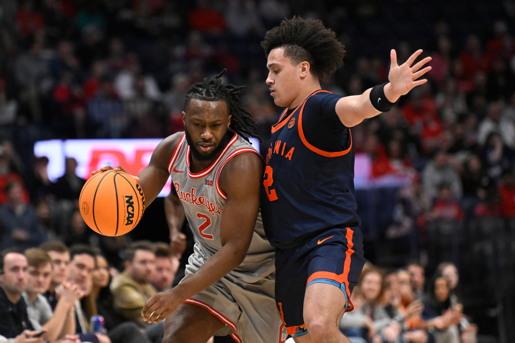 Ohio State guard Bruce Thornton (2) drives as Virginia guard Chance Mallory (2) defends during the first half of an NCAA college basketball game Saturday, Feb. 14, 2026, in Nashville, Tenn. (AP Photo/John Amis)