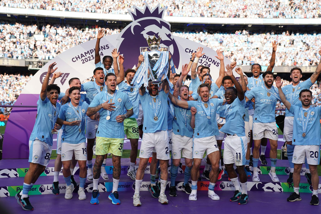 FILE - Manchester City players celebrate with the Premier League trophy after the English Premier League soccer match between Manchester City and West Ham United in Manchester, England, Sunday, May 19, 2024. (AP Photo/Dave Thompson, File)