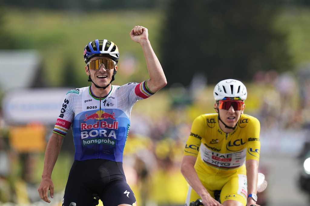 Belgium's Remco Evenepoel celebrates as he crosses the finish line ahead Slovenia's Tadej Pogacar to win the fifteenth stage of the Tour de France cycling race, from Champagnole to the Plateau de Solaison, France, Sunday, July 19, 2026. (AP Photo/Thibault Camus)