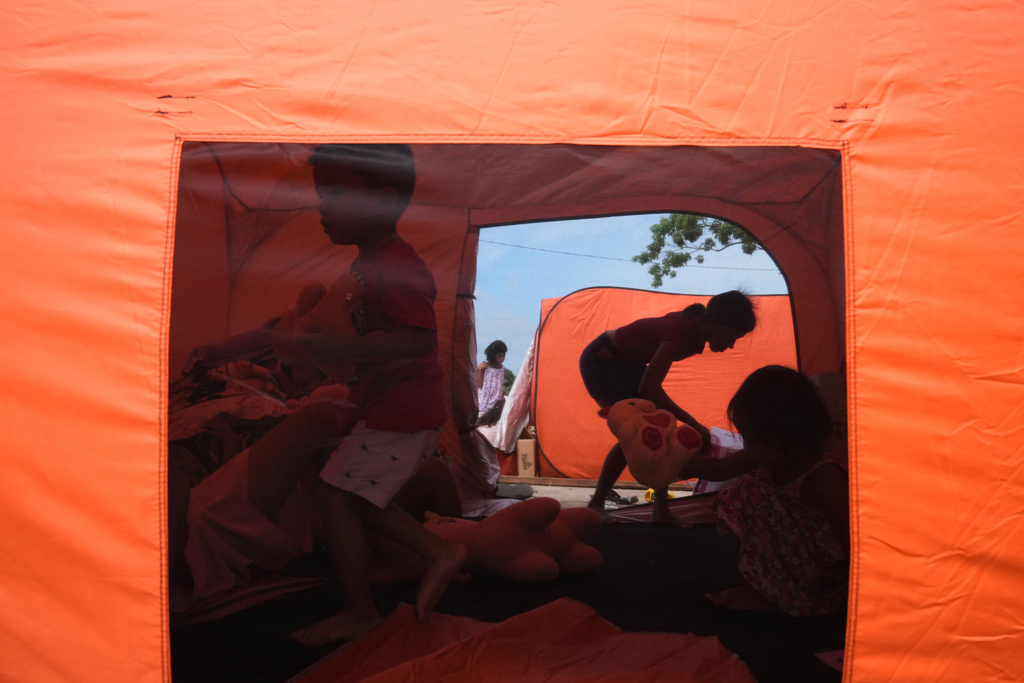 Earthquake survivors stay in tents on Thursday, Oct. 2, 2025 after Tuesday's strong quake in San Remigio, Cebu Province, Central Philippines. (AP Photo/Aaron Favila)