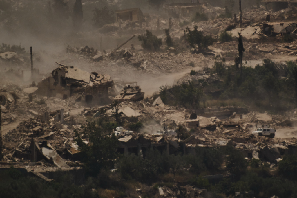 FILE - An Israeli tank moves past a convoy of the United Nations peacekeeping forces in Lebanon (UNIFIL) in southern Lebanon, as seen from northern Israel on June 26, 2026. (AP Photo/Leo Correa, File)
