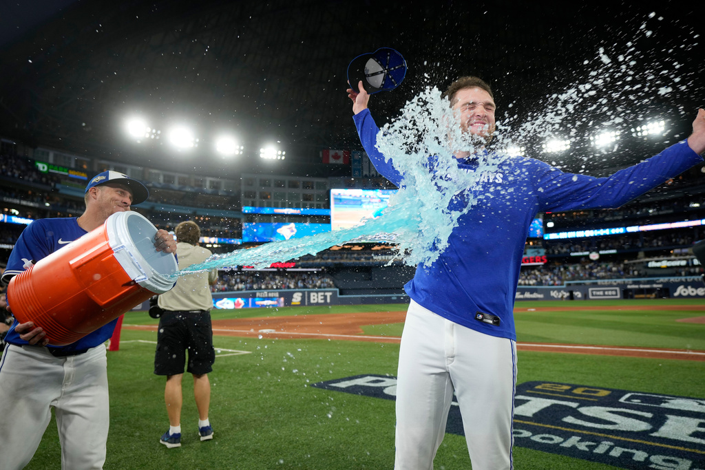 Toronto Blue Jays pitcher Trey Yesavage, right, is doused by teammate Myles Straw, left, after their team's win over the New York Yankees in Game 2 of baseball's American League Division Series in Toronto, Sunday, Oct. 5, 2025. (Frank Gunn/The Canadian Press via AP)