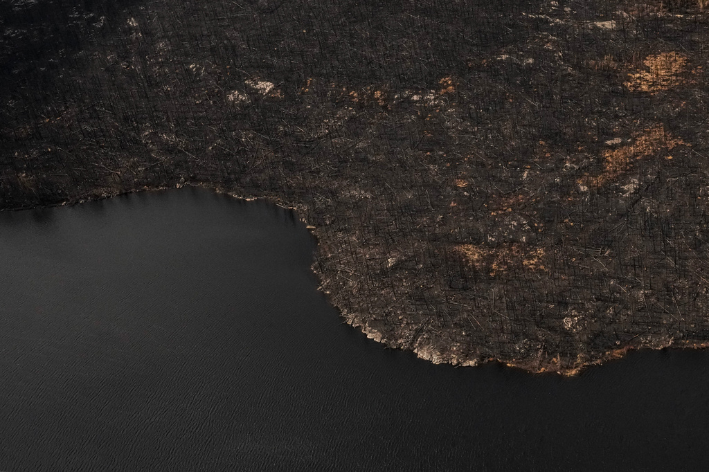 FILE - Wildfire damage is visible in the immediate area surrounding Collins First Nation, a small, remote Ojibwa community in northwestern Ontario, July 22, 2026. (Chris Young/The Canadian Press via AP, File)