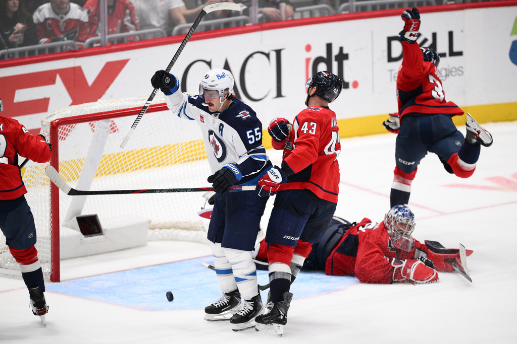 Winnipeg Jets center Mark Scheifele (55) celebrates his goal during the third period of an NHL hockey game against the Washington Capitals, Wednesday, Nov. 26, 2025, in Washington. (AP Photo/Nick Wass)