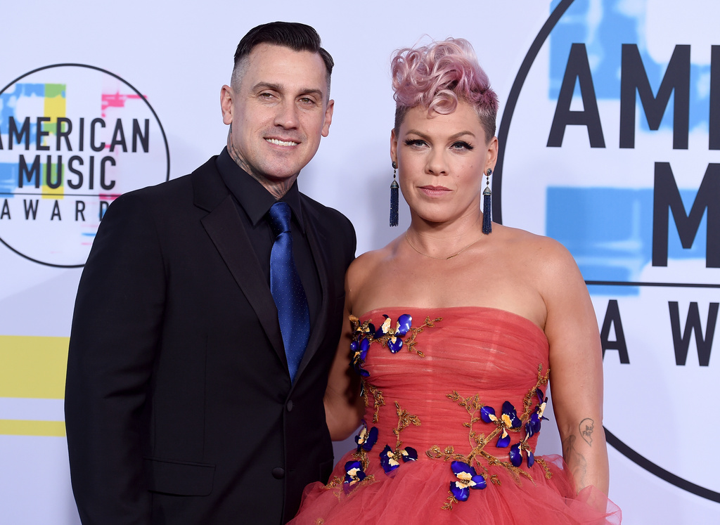 FILE - Singer Pink, right, and Carey Hart appear at the American Music Awards in Los Angeles on Nov. 19, 2017. (Photo by Jordan Strauss/Invision/AP, File)