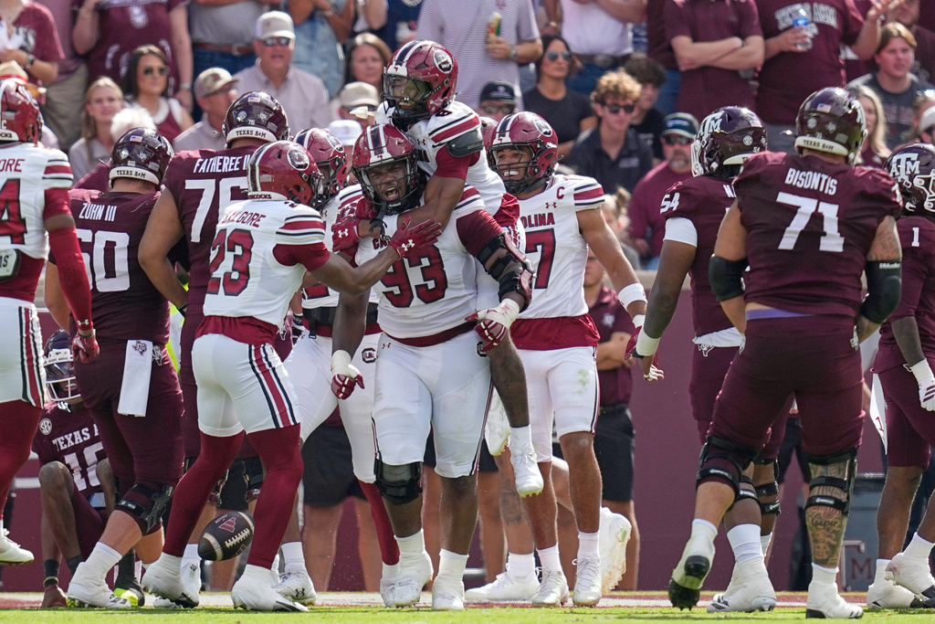 South Carolina defensive lineman Nick Barrett (93) celebrates with Judge Collier (8) after returning a fumble by Texas A&M quarterback Marcel Reed for a touchdown during the first half of an NCAA college football game Saturday, Nov. 15, 2025, in College Station, Texas. (AP Photo/David J. Phillip)