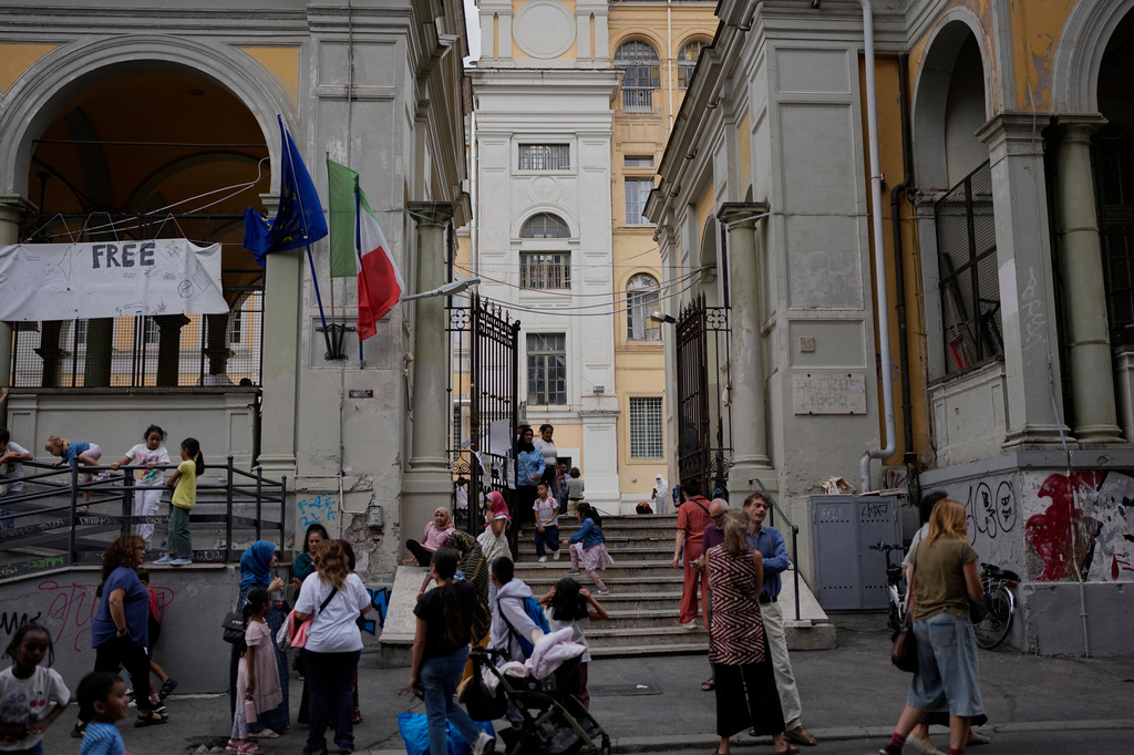 Parents and relatives wait for their children exit in a school in downtown Rome, Thursday, Sept. 24, 2026. (AP Photo/Alessandra Tarantino)