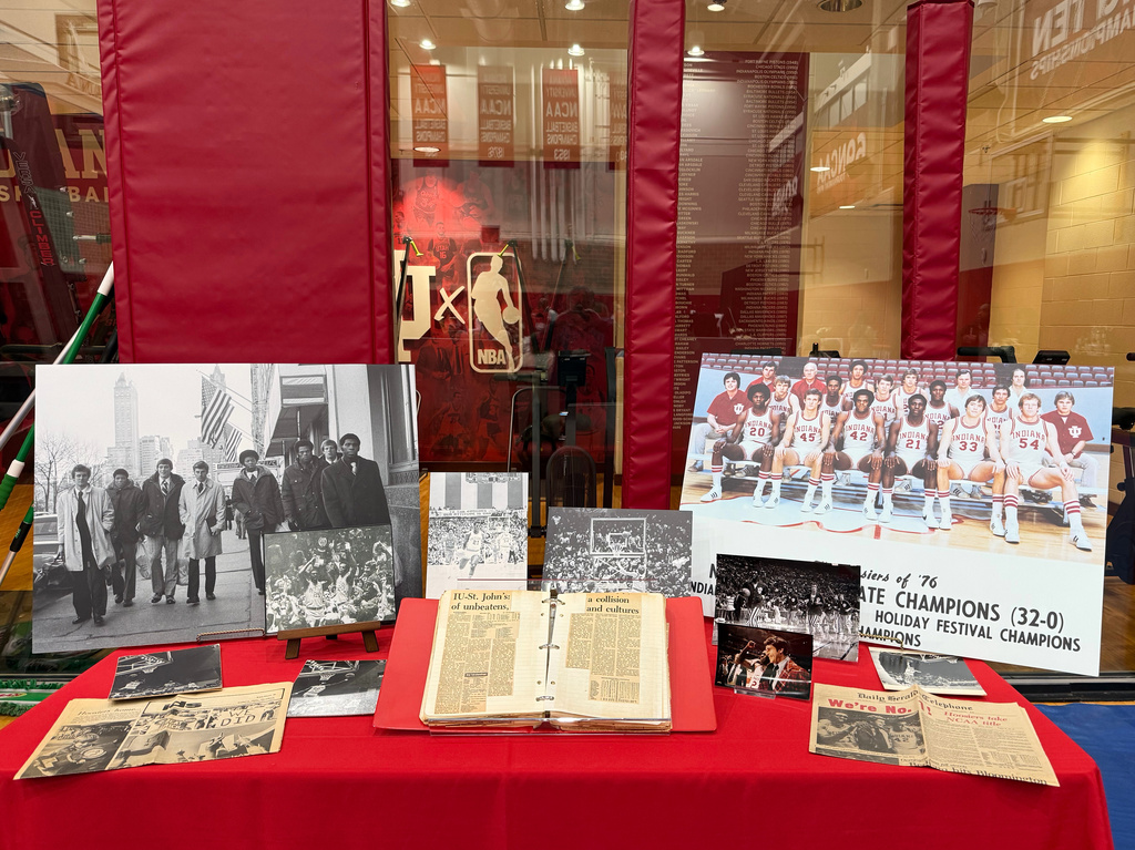 Photos and memorabilia from the Indiana Hoosiers 1975-76 national championship team, the last undefeated men's Division I team to win the championship, is displayed before a basketball game against Oregon on Feb. 9, 2026, in Bloomington, Ind. (AP Photo/Mike Marot)