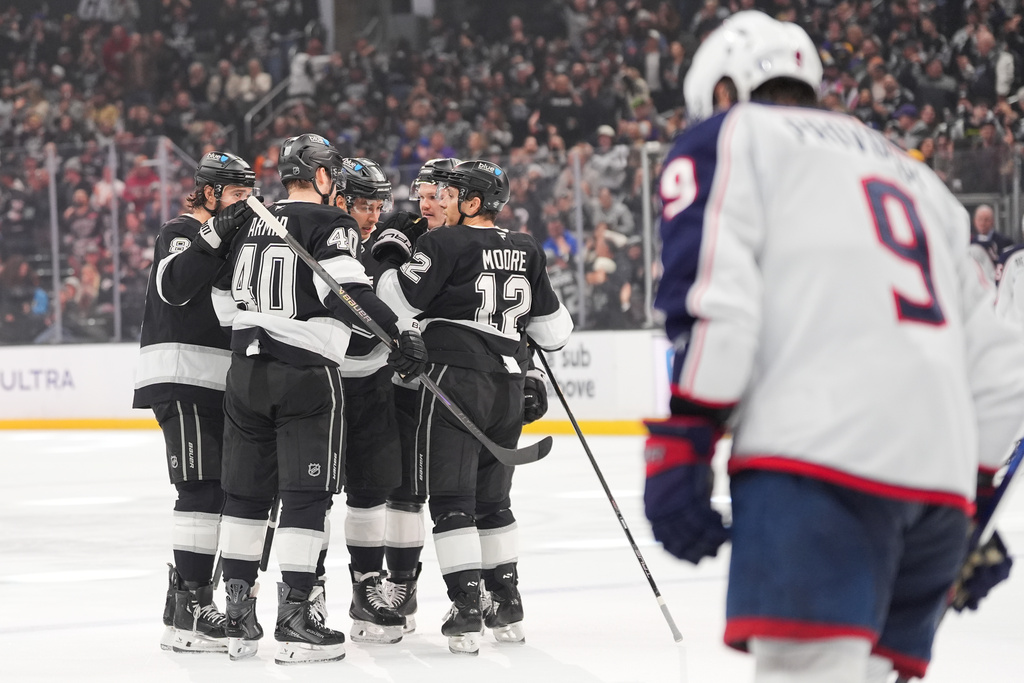 Los Angeles Kings players celebrate a goal by Andrei Kuzmenko during the second period of an NHL hockey game against the Columbus Blue Jackets Monday, Dec. 22, 2025, in Los Angeles. (AP Photo/Jae C. Hong)