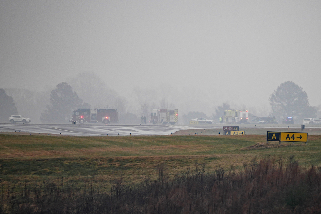 First responders tend to the scene of a reported plane crash at a regional airport in Statesville, N.C., Thursday, Dec. 18, 2025. (AP Photo/Matt Kelley)