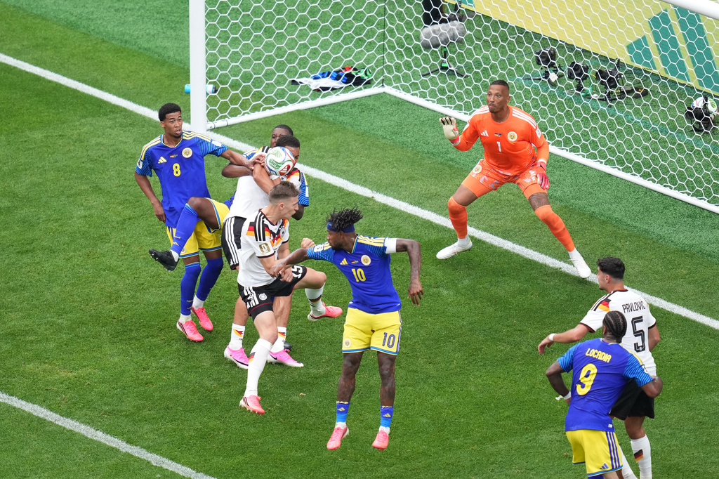 Germany's Nico Schlotterbeck (15) scores their second goal against Curaçao goalkeeper Eloy Room (1) during the World Cup Group E soccer match between Germany and Curacao in Houston, Sunday, June 14, 2026. (AP Photo/Eric Smith)