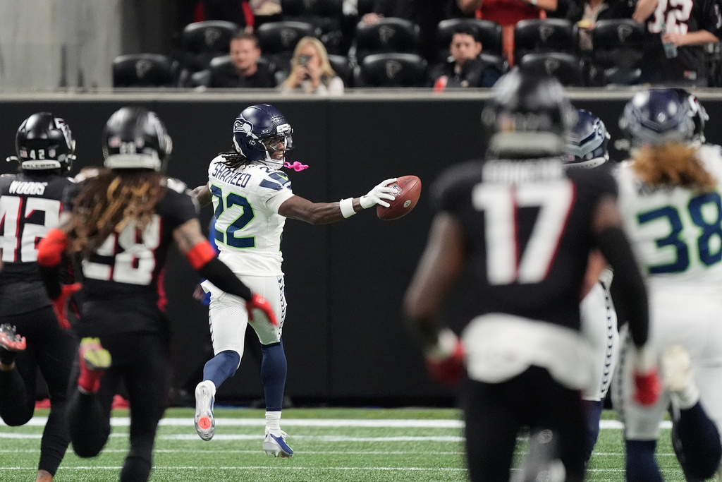 Seattle Seahawks wide receiver Rashid Shaheed (22) looks back as he runs for a touchdown on a kickoff return against the Atlanta Falcons during the second half of an NFL football game, Sunday, Dec. 7, 2025, in Atlanta. (AP Photo/Mike Stewart)